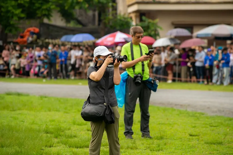 Photographers focusing on the vibrant scenes at Bac Ha Horse Racing Festival in Lào Cai, Vietnam.